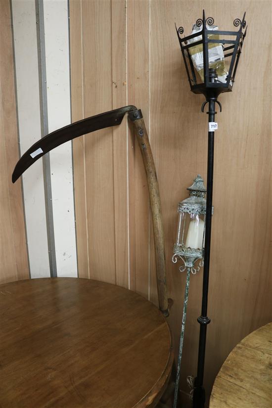 A scythe and two metal lamps
